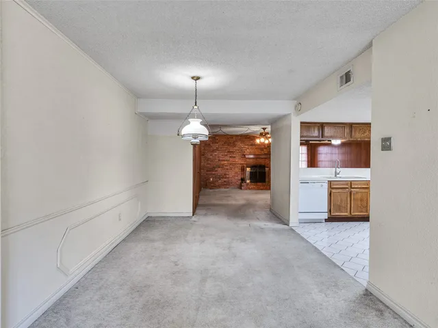 an empty room with a kitchen and a sink