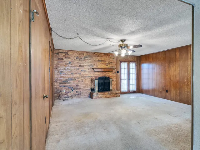 wooden floor in an empty room with a fireplace