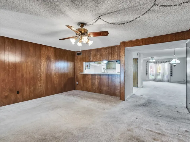 an empty room with fan and entrance