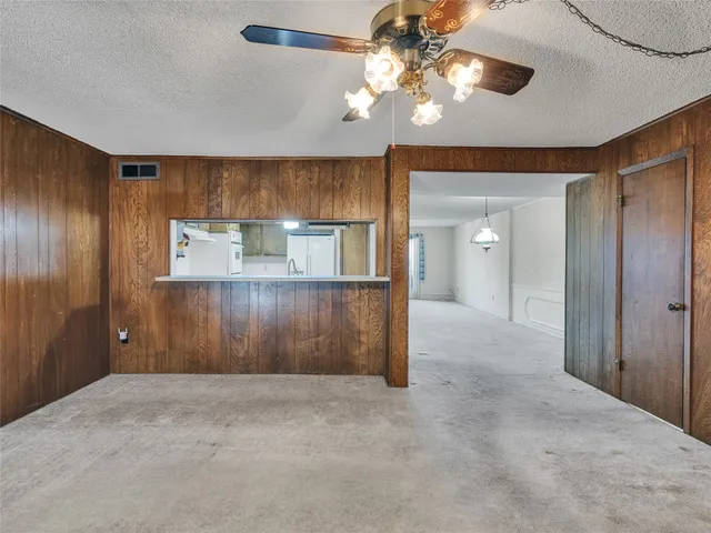 a view of a livingroom with a chandelier fan