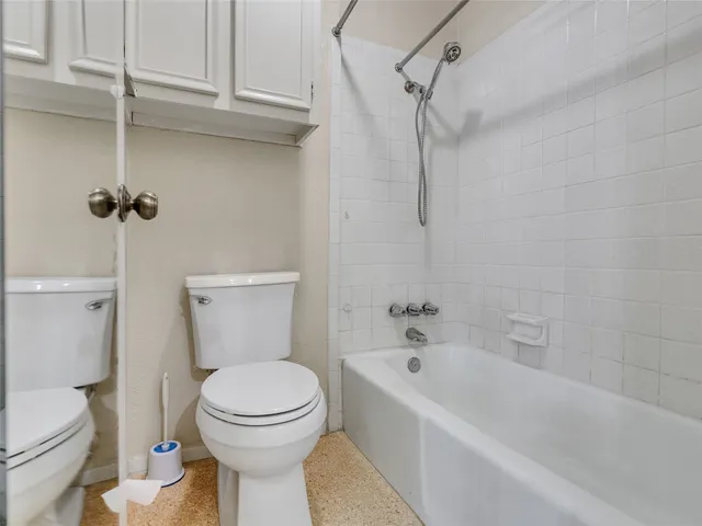 a bathroom with a toilet and a bathtub