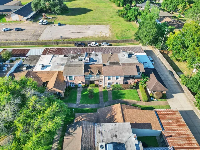 an aerial view of a house with garden space and street view