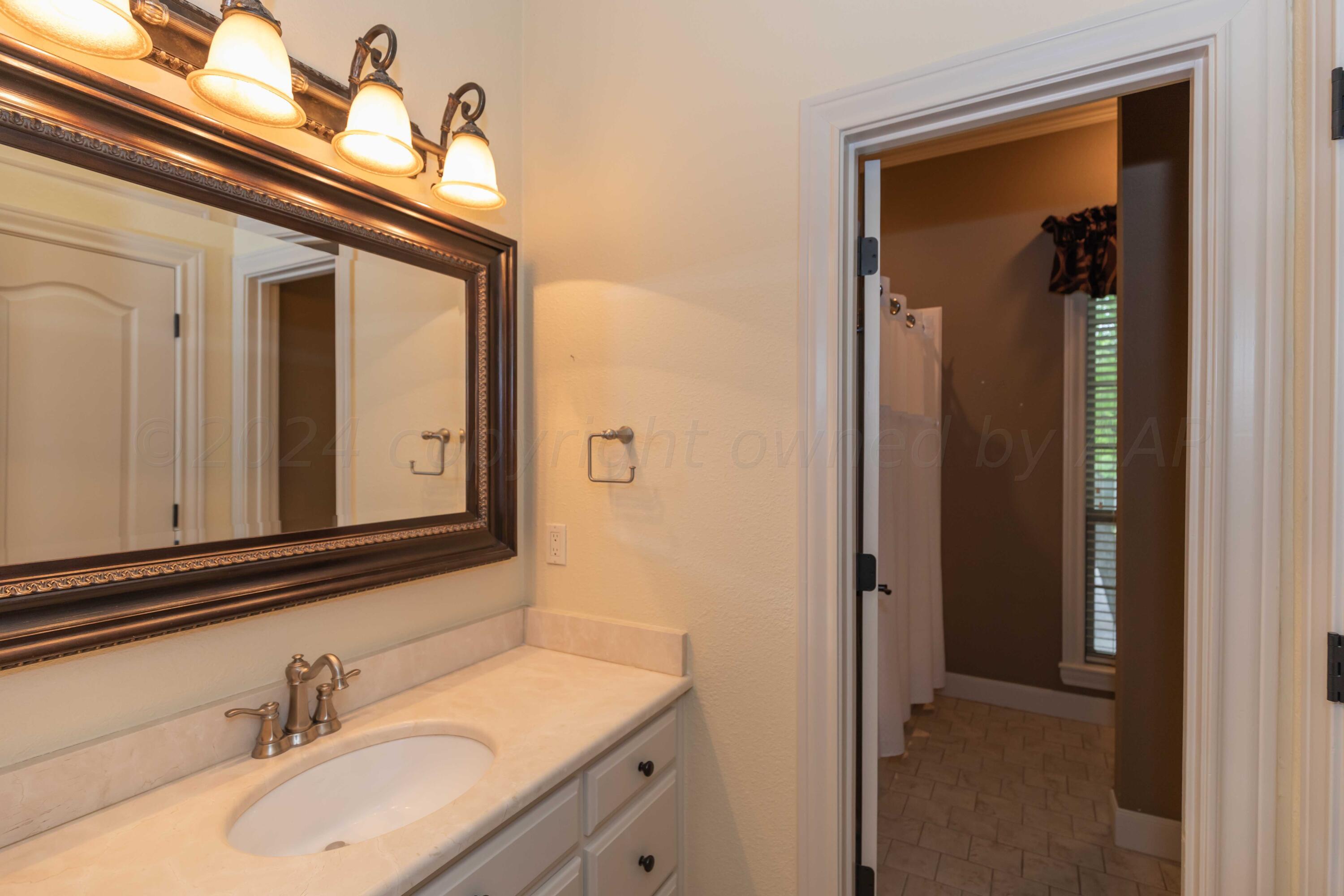 17 Cypress Point Amarillo, TX 79124 - Photo 27 of 72 a bathroom with a sink and a mirror