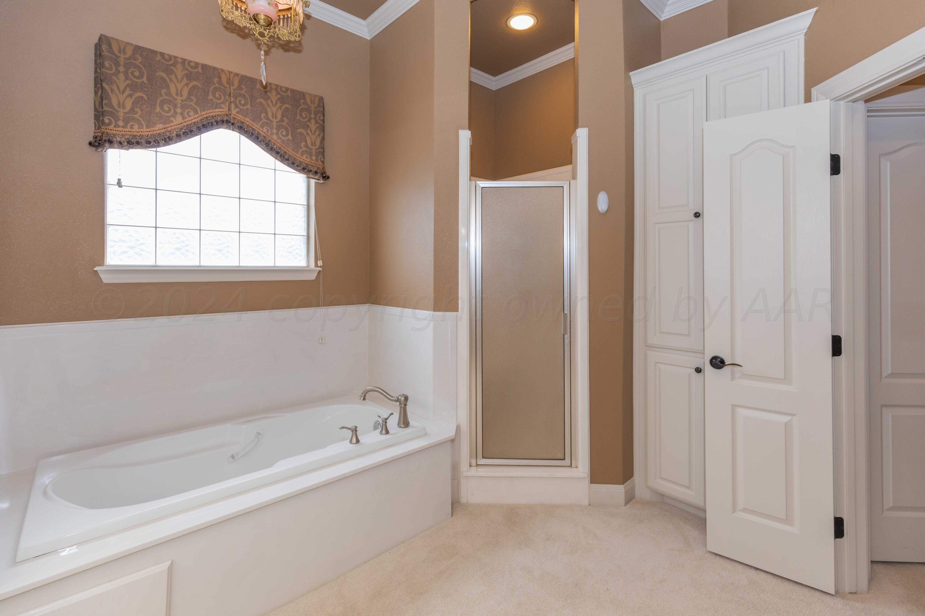 17 Cypress Point Amarillo, TX 79124 - Photo 64 of 72 a bathroom with a bathtub and a shower