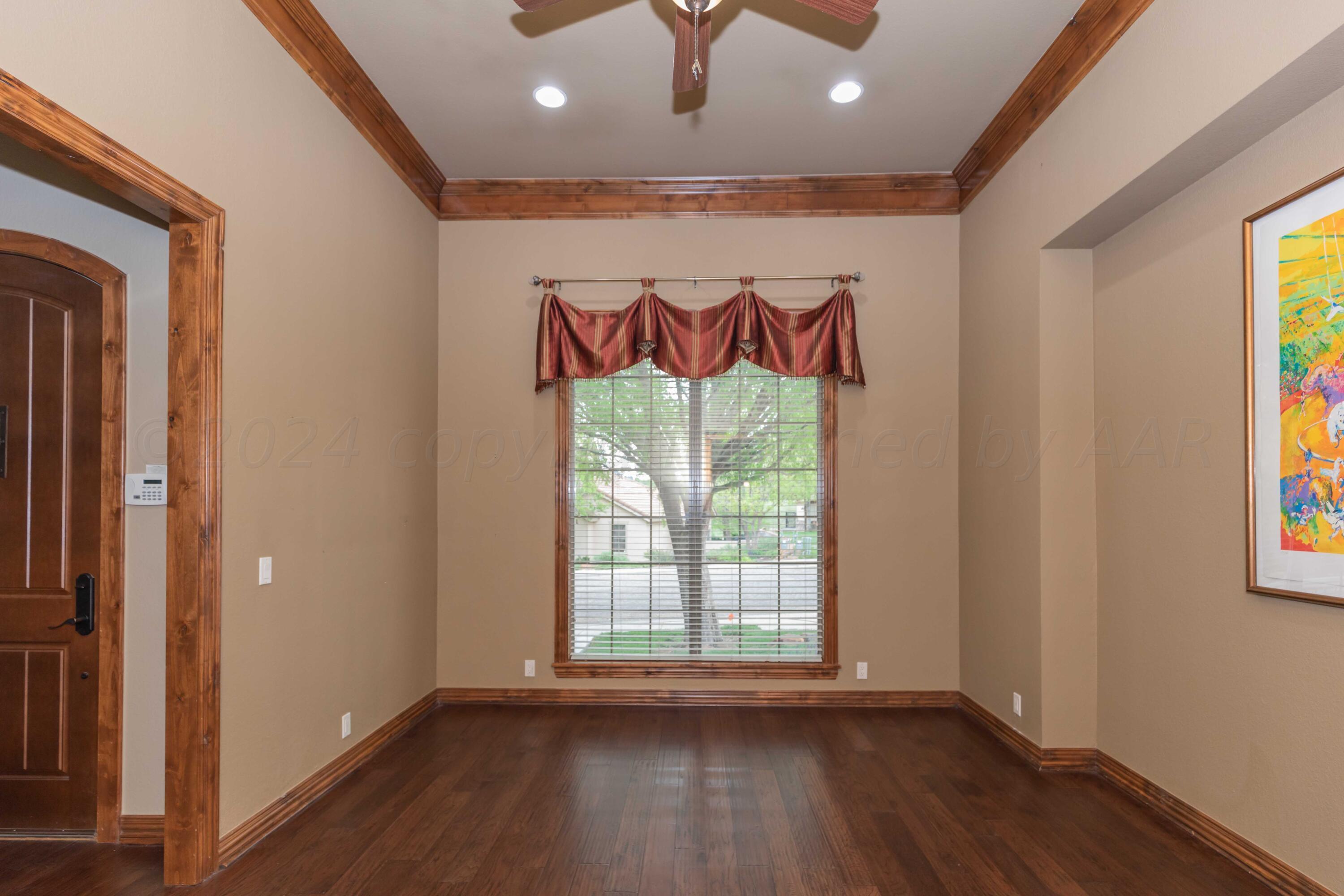 17 Cypress Point Amarillo, TX 79124 - Photo 10 of 72 a view of an empty room with wooden floor and a window