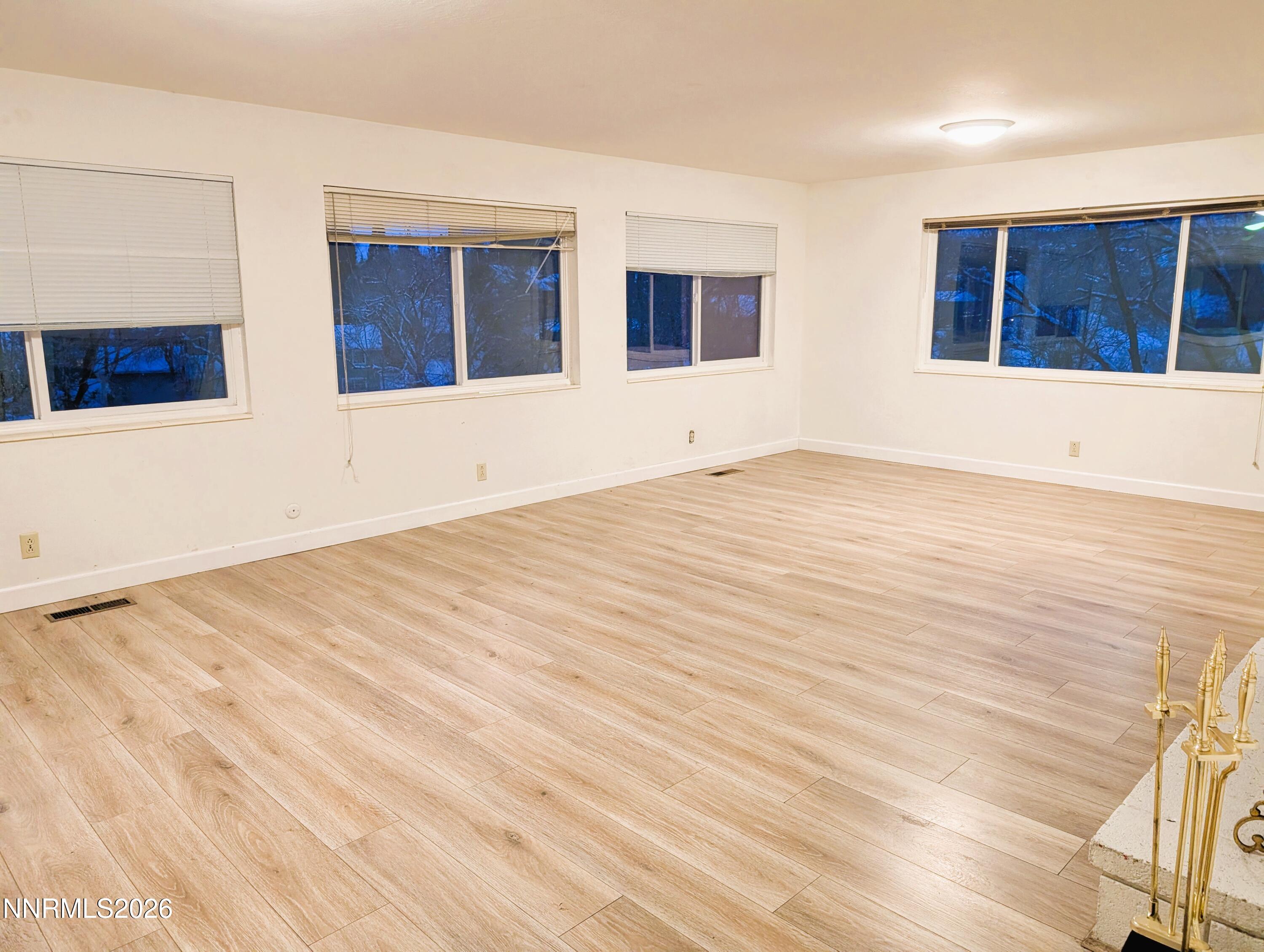 2390 Barnes Circle Reno, NV 89509 - Photo 11 of 13 a view of an empty room with wooden floor and windows