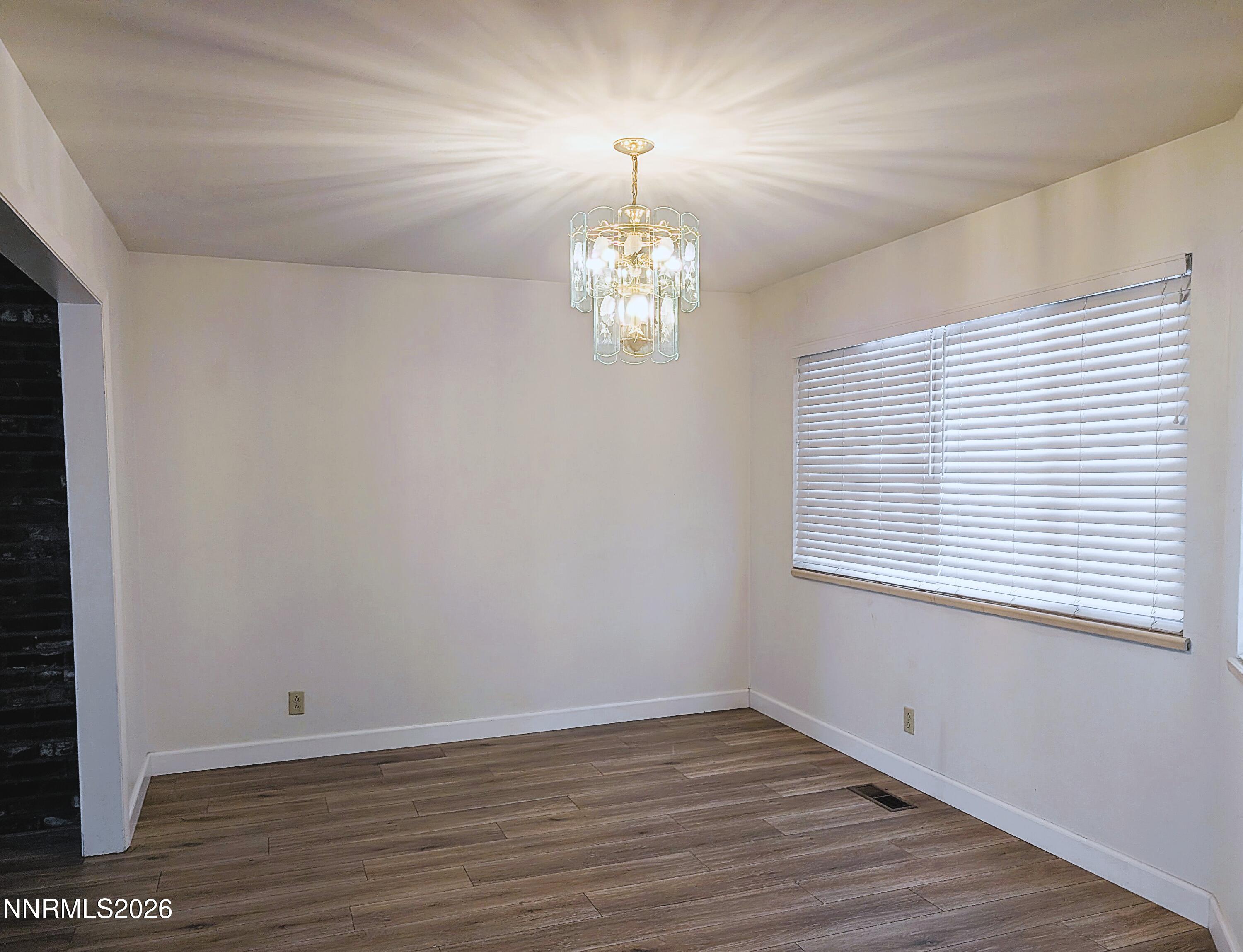 2390 Barnes Circle Reno, NV 89509 - Photo 3 of 13 wooden floor in an empty room with a window