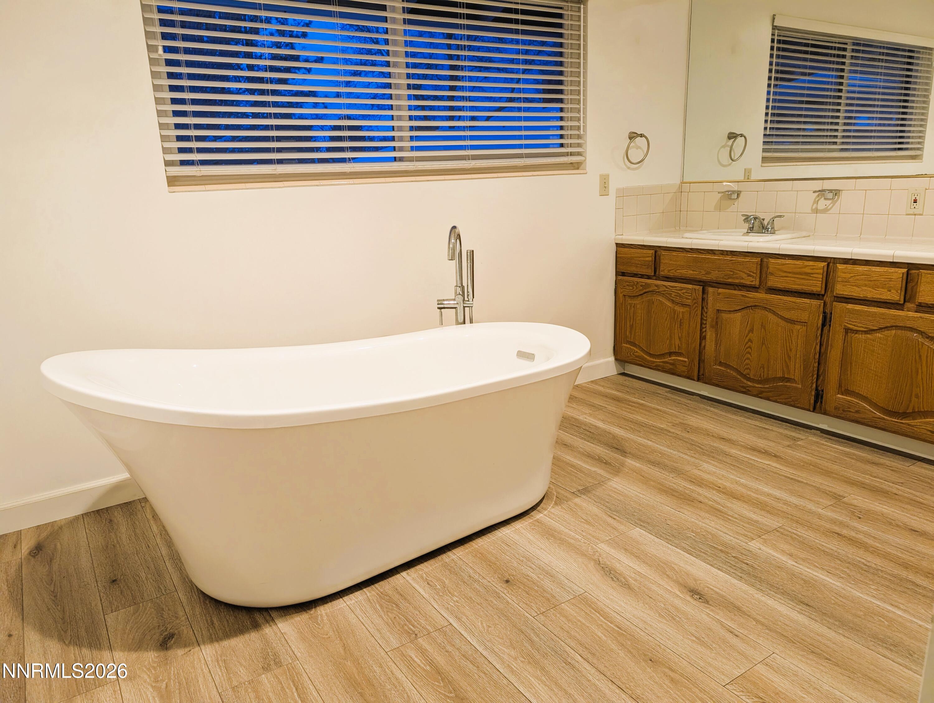 2390 Barnes Circle Reno, NV 89509 - Photo 9 of 13 a white bath tub sitting next to a bathroom sink