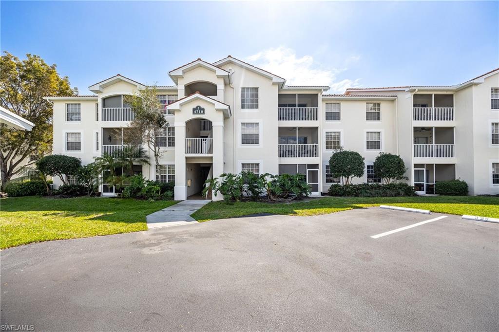 4710 St Croix Lane, Unit 216 Naples, FL 34109 - Photo 1 of 29 a front view of house with yard and trees