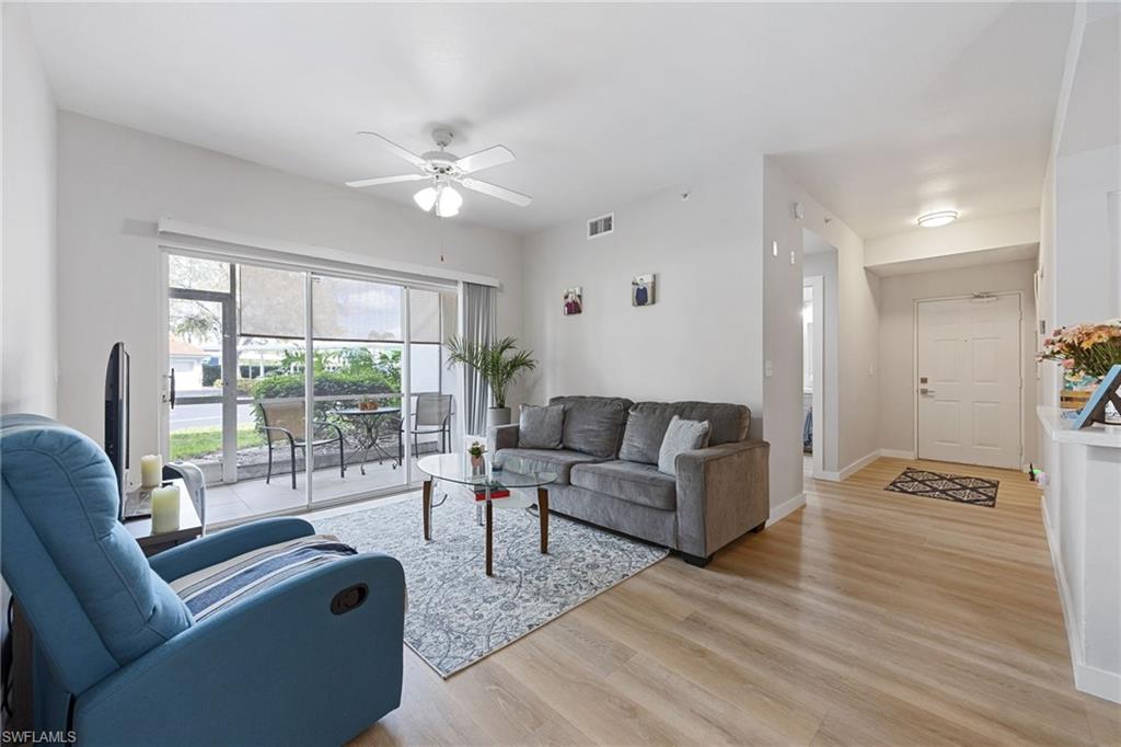 4710 St Croix Lane, Unit 216 Naples, FL 34109 - Photo 13 of 29 a living room with furniture and a large window