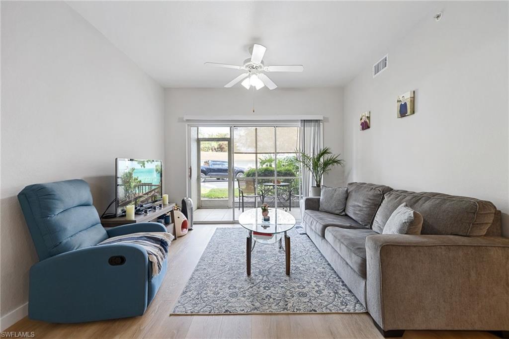 4710 St Croix Lane, Unit 216 Naples, FL 34109 - Photo 14 of 29 a living room with furniture and a large window