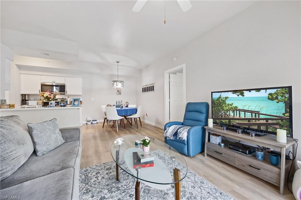 4710 St Croix Lane, Unit 216 Naples, FL 34109 - Photo 15 of 29 a living room with furniture and a flat screen tv