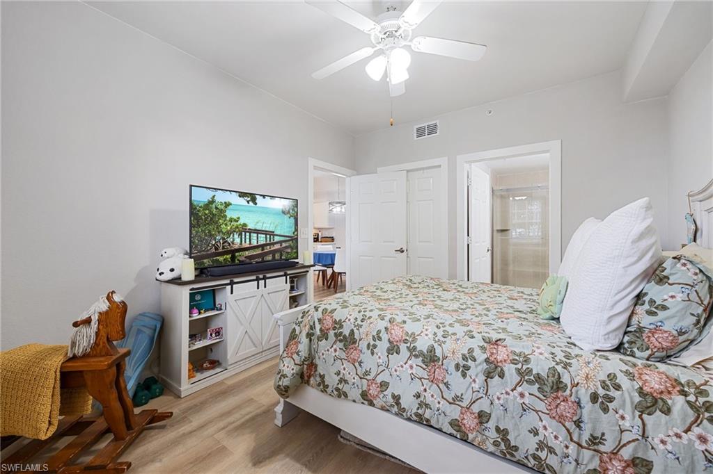 4710 St Croix Lane, Unit 216 Naples, FL 34109 - Photo 18 of 29 a bedroom with a bed and a flat screen tv