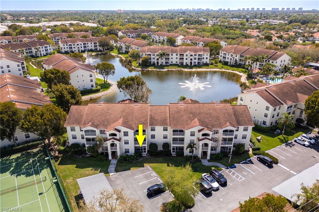 4710 St Croix Lane, Unit 216 Naples, FL 34109 - Photo 2 of 29 an aerial view of a house with swimming pool and ocean view