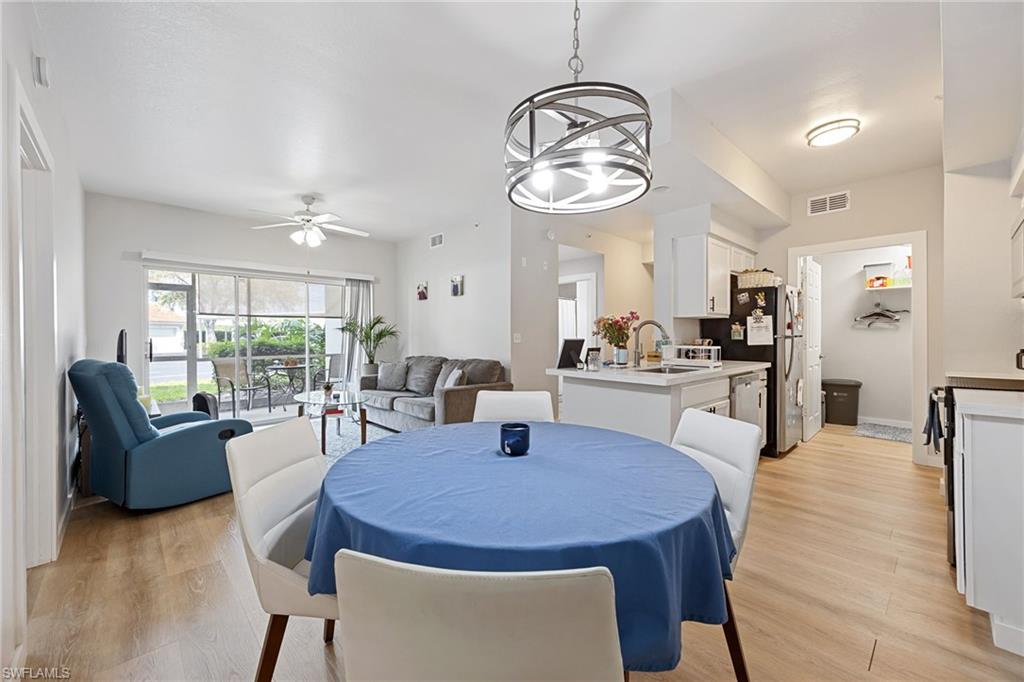 4710 St Croix Lane, Unit 216 Naples, FL 34109 - Photo 5 of 29 a view of a dining room with furniture and a chandelier