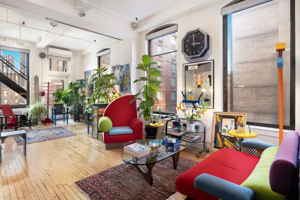 a living room with furniture a rug and a window