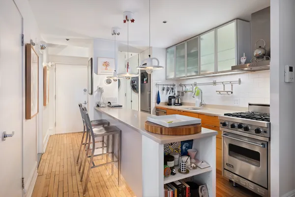 a kitchen with stainless steel appliances granite countertop a stove and a refrigerator