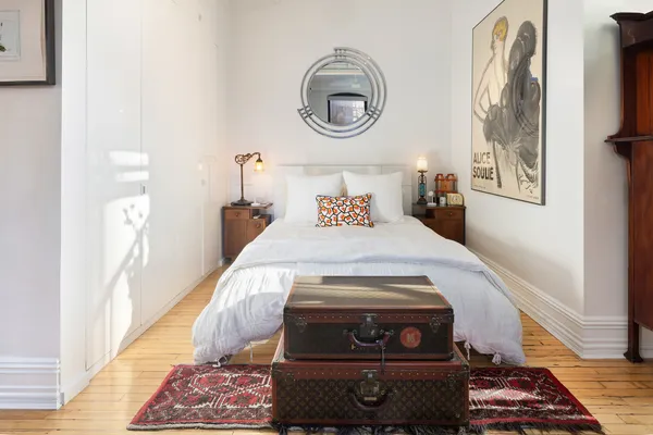 a bedroom with a bed and a window