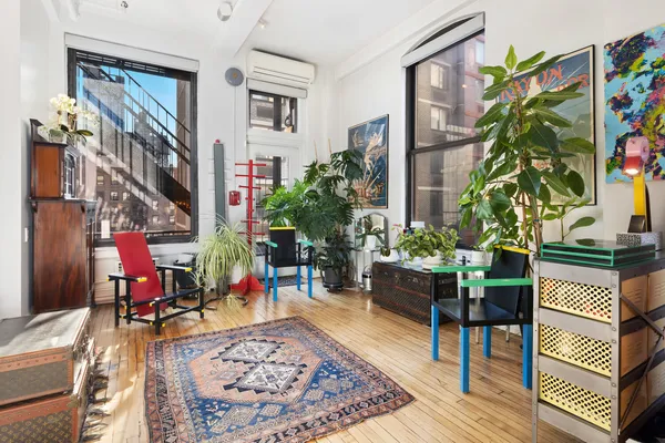 a living room filled with furniture and a potted plant