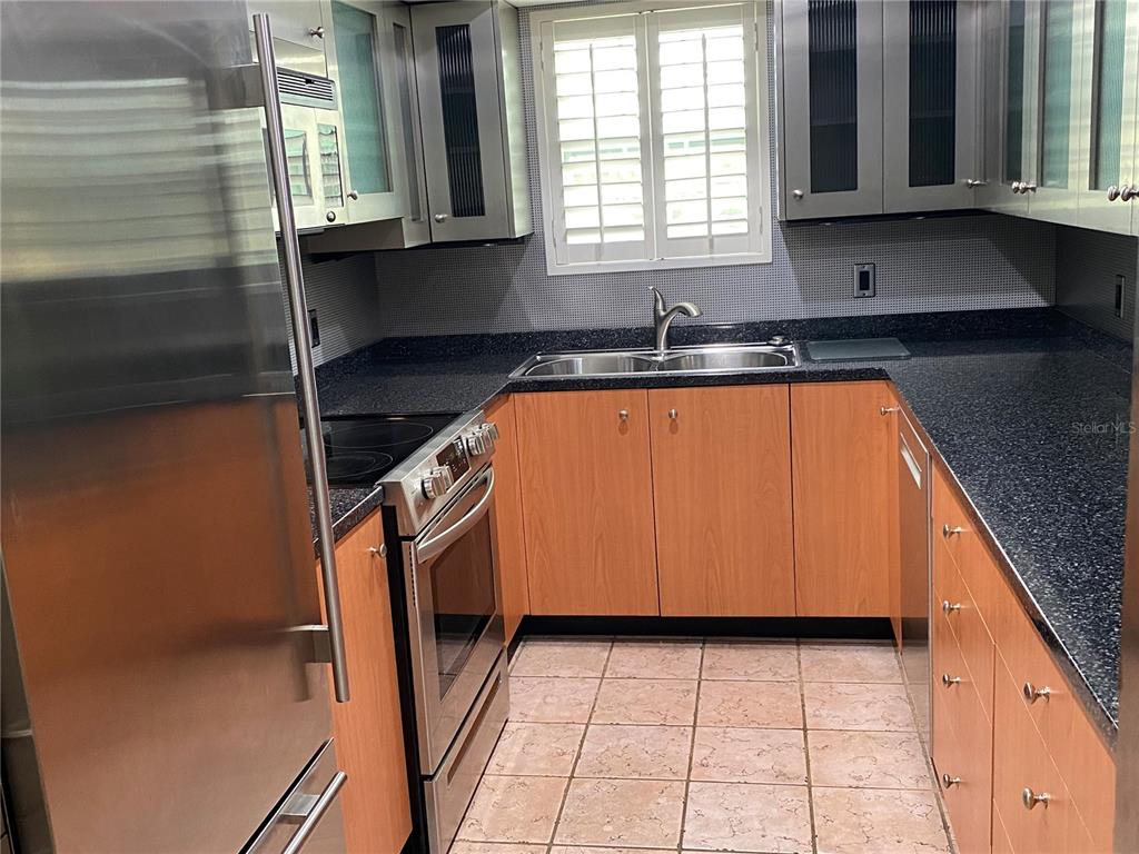 1500 Gay Road, Unit 17D Winter Park, FL 32789 - Photo 13 of 34 a kitchen with a sink a stove and cabinets