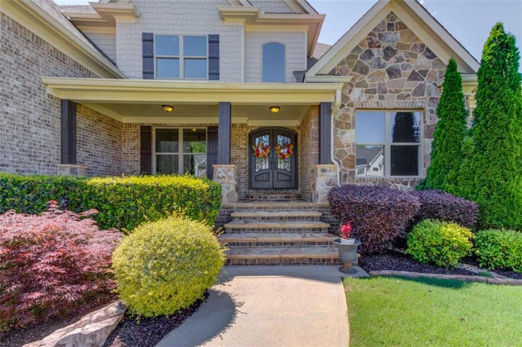 a front view of a house with a garden