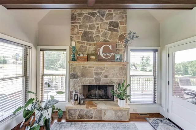 a dining room with furniture a chandelier and wooden floor