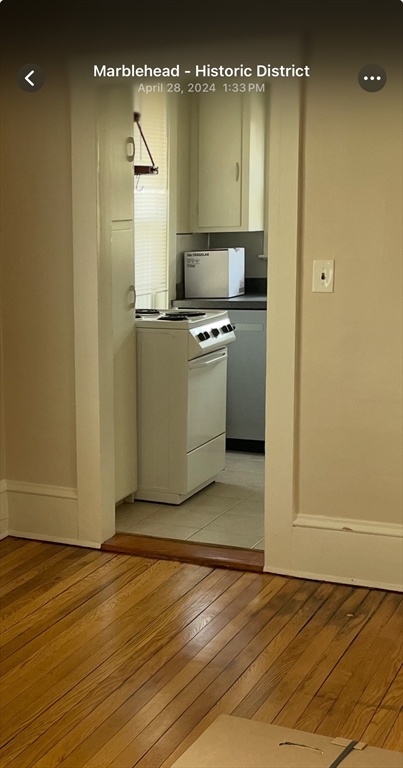 15 Harris Street, Unit 2 Marblehead, MA 01945 - Photo 8 of 12 a view of a kitchen with a sink and dishwasher a refrigerator with wooden floor