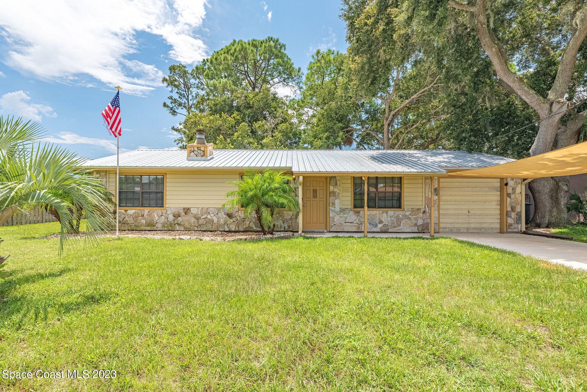 4505 Comfort Street Cocoa, FL 32927 - Photo 1 of 30 a front view of a house with a yard and garage