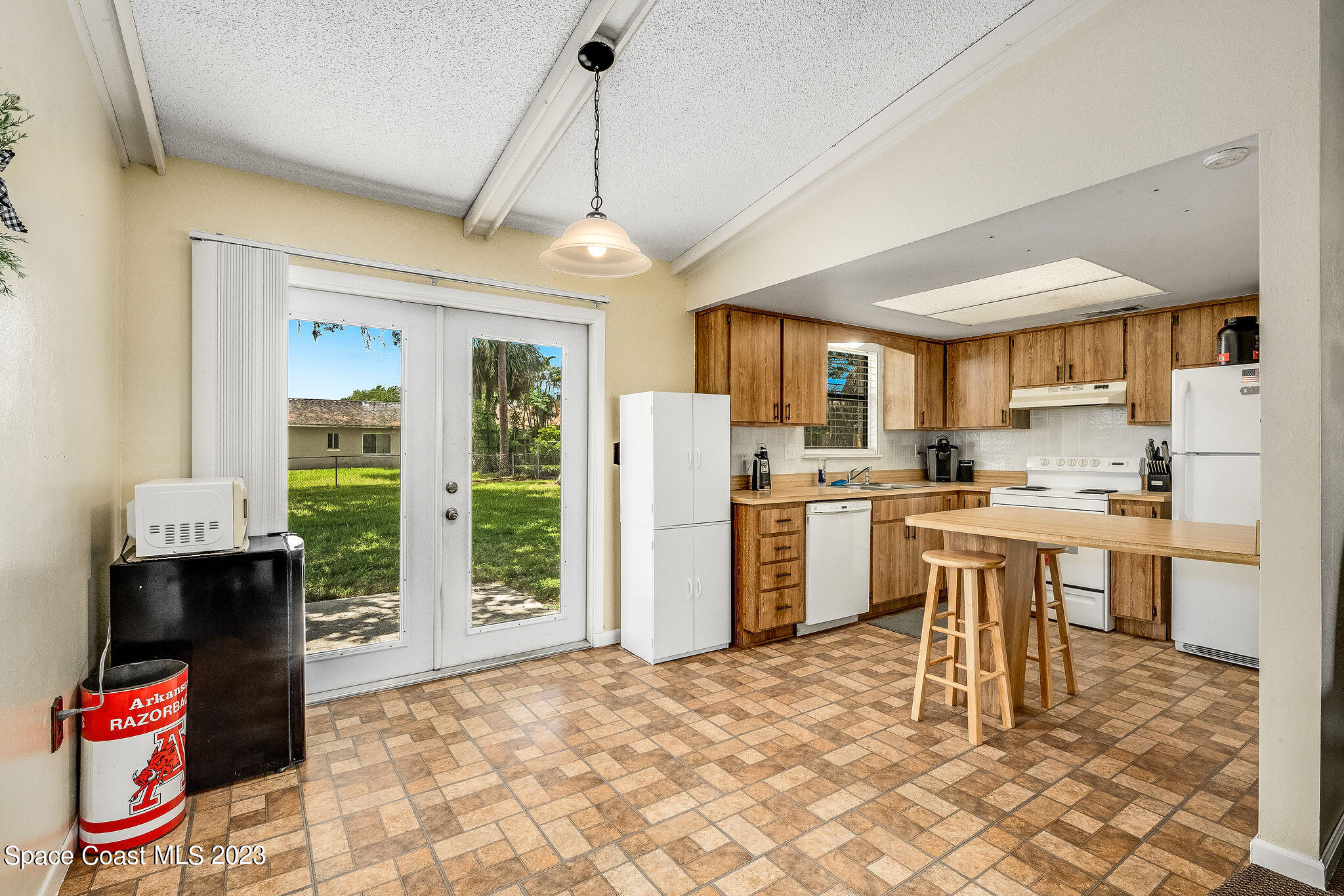 4505 Comfort Street Cocoa, FL 32927 - Photo 5 of 30 a open kitchen that has a lot of cabinets refrigerator oven and a sink