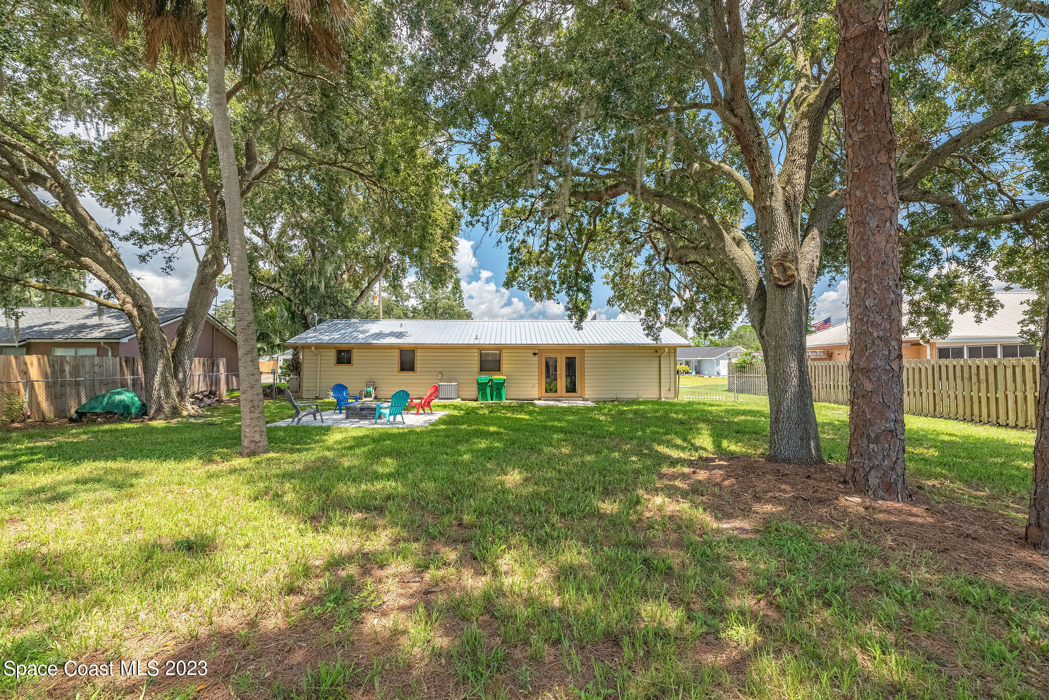 4505 Comfort Street Cocoa, FL 32927 - Photo 10 of 30 a view of a house with a big yard and large trees