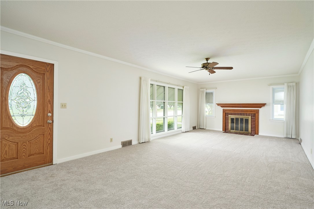 415 West Waterloo Road Akron, OH 44314 - Photo 13 of 24 LIVING ROOM W/FIREPLACE, NEWER CARPET, LOVELY FRONT DOOR W/LEAD GLASS