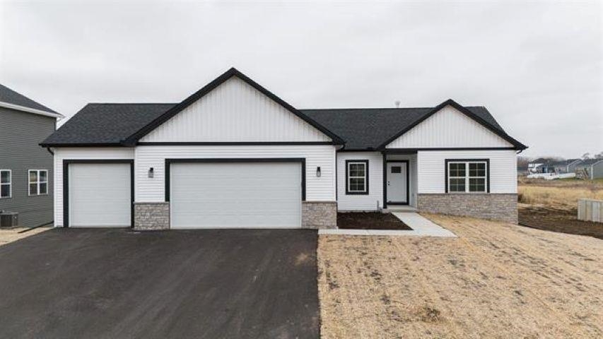14212 Prairie Commons Lane South Beloit, IL 61080 - Photo 1 of 23 a front view of a house with a yard and garage