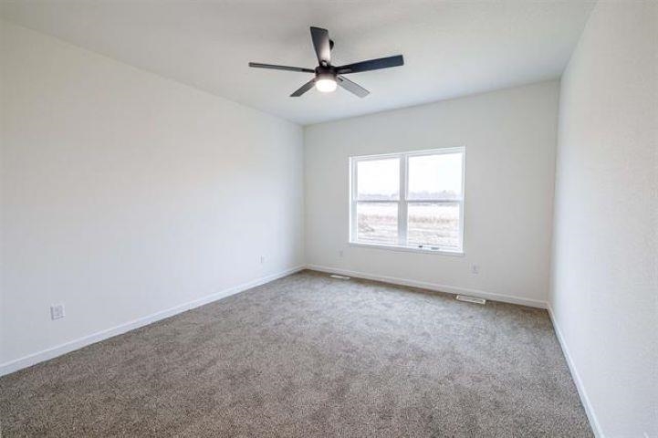 14212 Prairie Commons Lane South Beloit, IL 61080 - Photo 12 of 23 an empty room with windows and ceiling fan