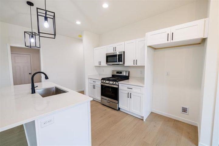 14212 Prairie Commons Lane South Beloit, IL 61080 - Photo 6 of 23 a kitchen with stainless steel appliances granite countertop a sink and a stove top oven