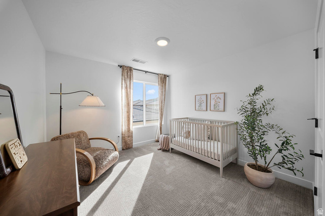 382 North Rhyolite Drive, Unit 111 Hurricane, UT 84737 - Photo 27 of 37 Bright interior room featuring a large window with privacy blinds, light gray textured carpeting, and white walls