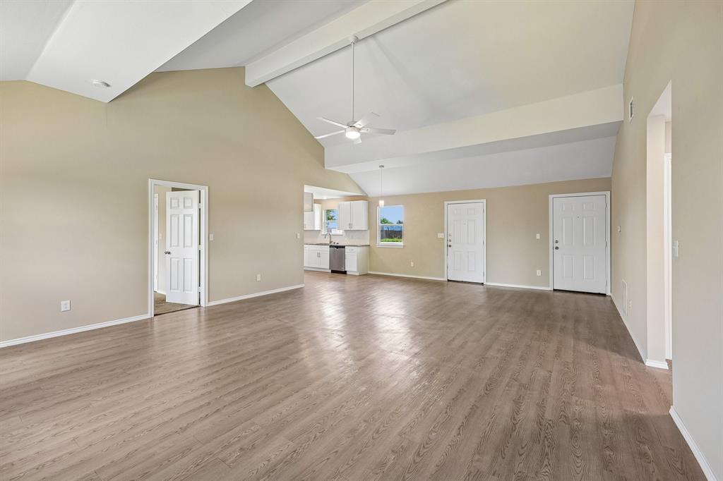 433 Whitney Court Rio Vista, TX 76093 - Photo 5 of 27 a view of a livingroom with wooden floor and a kitchen