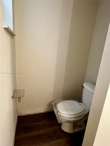 a white toilet sitting next to a shower