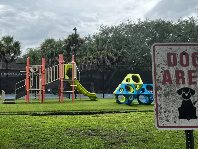a view of play ground with entertaining space and plants