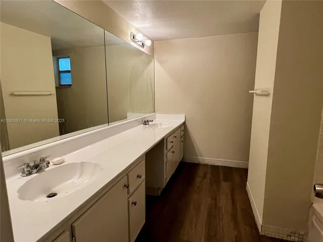a bathroom with a double vanity sink and mirror