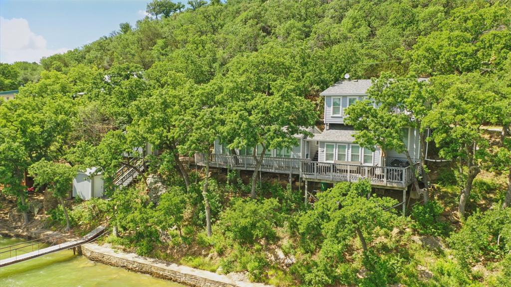 306 Chism Trail Gordon, TX 76453 - Photo 1 of 38 a view of a large yard with large trees and plants