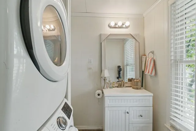 a bathroom with a sink mirror and vanity