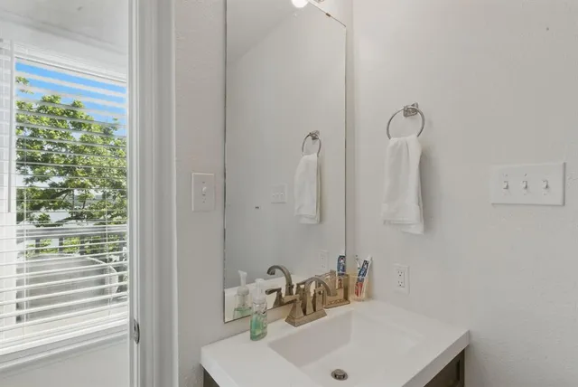 a bathroom with a sink and a window