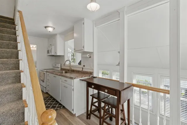 a kitchen with a sink appliances and cabinets