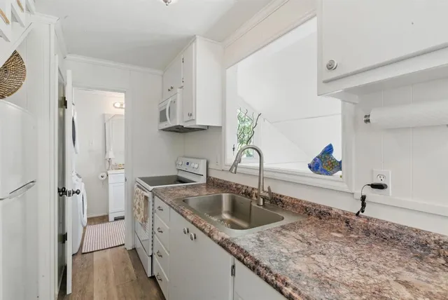 a kitchen with a sink stove and cabinets