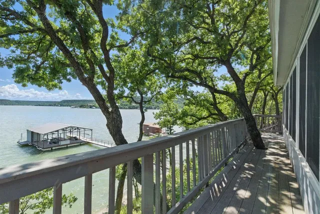 a wooden bench sitting in front of a building