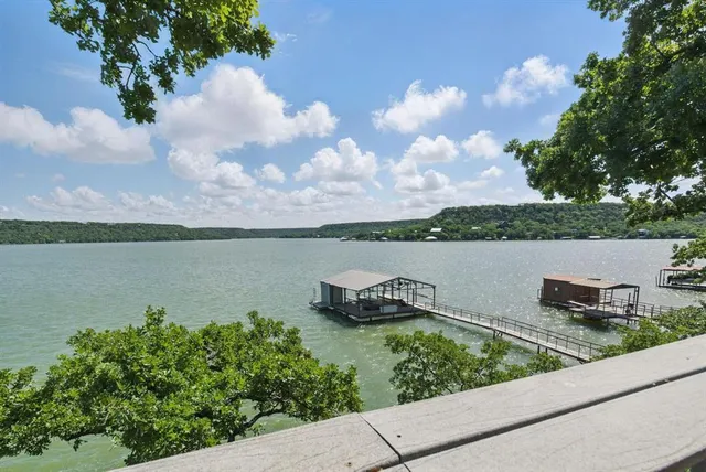 a view of a lake with houses in the back