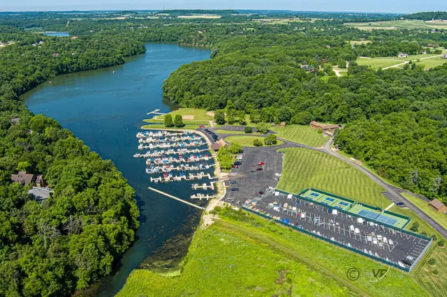 an aerial view of residential houses with outdoor space and swimming pool