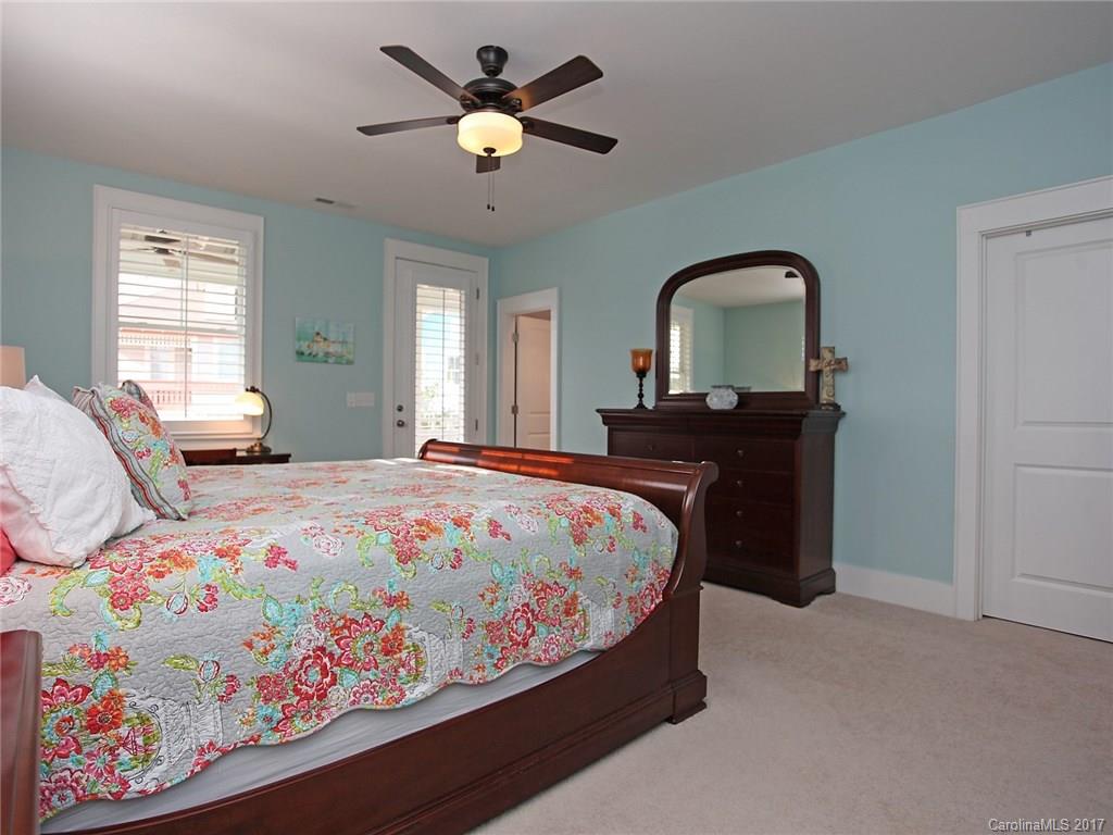 409 Hollyhock Lane Fort Mill, SC 29708 - Photo 14 of 24 a bedroom with a bed and a chandelier