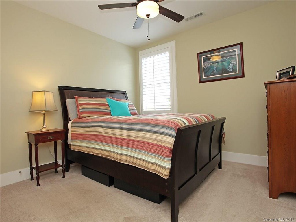 409 Hollyhock Lane Fort Mill, SC 29708 - Photo 22 of 24 a bedroom with a bed and a chandelier