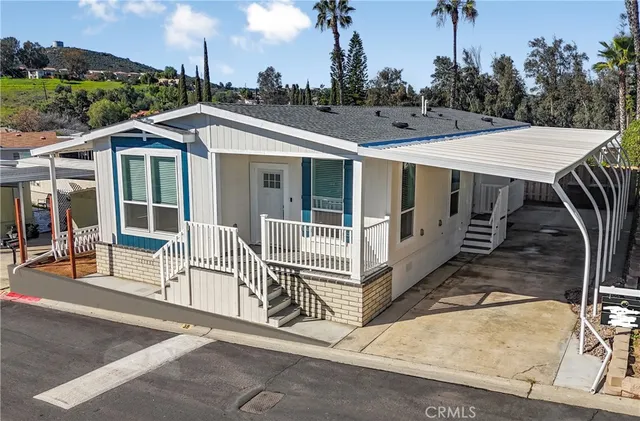 a view of a patio with a table chairs and a floor to ceiling window
